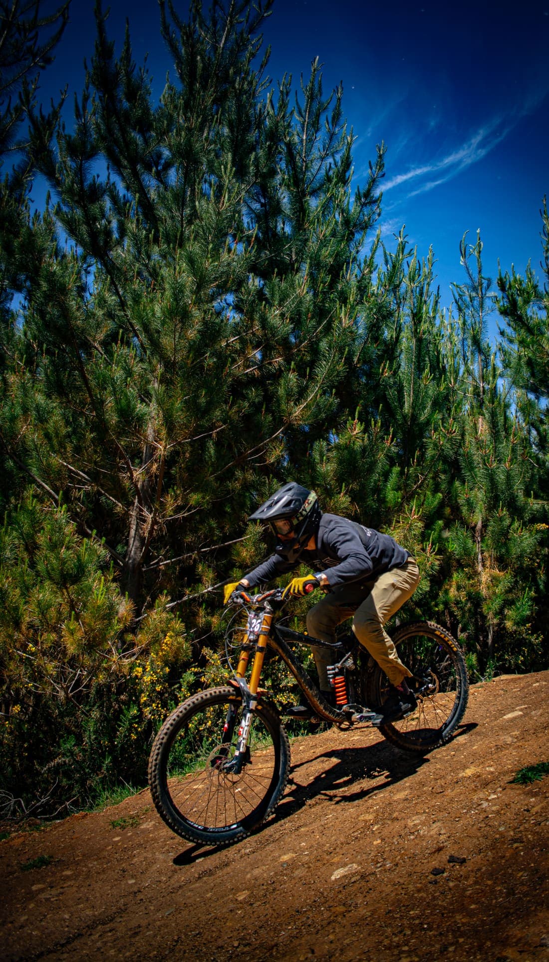 Rider bajando un peralte de tierra, dorsal 26